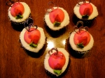Valentine cupcakes: rich chocolate with white sprinkled icing and strawberry accents--and silver hearts!