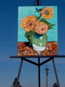 A replica of vanGogh's "Three Sunflowers in a Vase" on an easel.