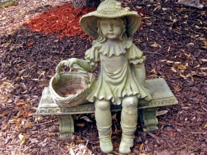 Statue of child with basket on stone bench.  (All pictures by Marylin Warner)