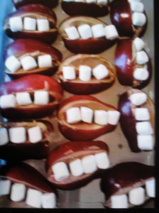Our daughter Molly made these Halloween "teeth" treats for her kids' class rooms: apples slices with peanut butter holding the marshmallow teeth.