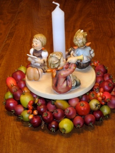Hummel figurines of young children singing, blowing horns, and beating drums. 