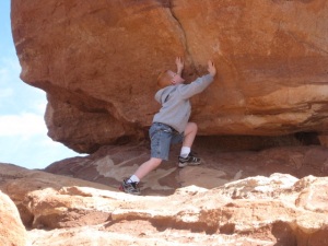 Who would dare a kid to try to push over a huge boulder in the Garden of the Gods?