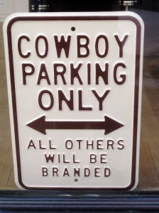 Abilene, KS (where the h.s. sports teams are the Cowboys and Cowgirls). I want a sign for writers: Writer Parking Only: All others will be rejected.  :)