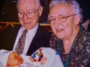 Ray and Mary holding their first great-grandchild, Grace
